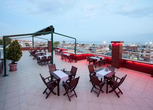 a restaurant with tables and chairs on a roof at Nanda Hotel in Istanbul