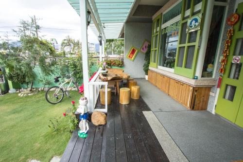 a porch of a store with a teddy bear standing on a deck at Vicking Guesthouse in Taitung City