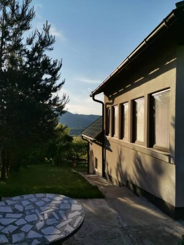 a house with a stone walkway next to a building at Sunset House Sarajevo in Sarajevo