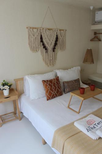 a bedroom with a large white bed and two tables at Alba Terra Houses in Pamukkale