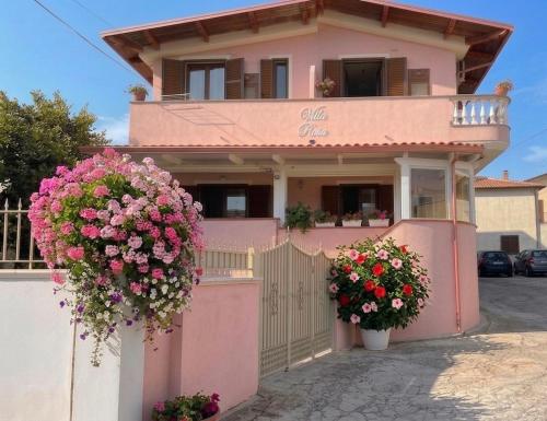 a pink house with flowers in front of it at Villa Rosa in Tropea