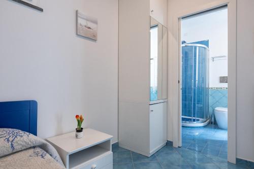 a bedroom with a bed and a bathroom with a tub at Levante - charming apartment with sea-view terrace, fits up to 7 guests in Maiori