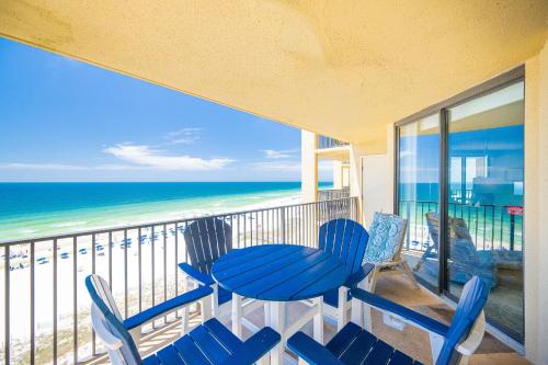 a balcony with a table and chairs and the ocean at Phoenix V 916 in Orange Beach