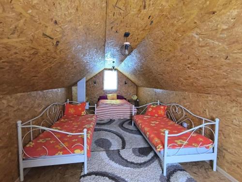 a room with two beds in a room with a wall at Apaurin Lodge - Peacful Nature Escape near Bosnian Pyramids in Visoko