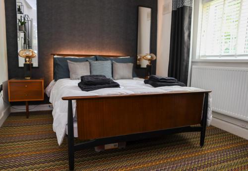 a bedroom with a bed with two towels on it at Century Apartments Manchester in Dukinfield