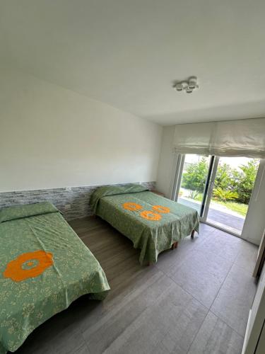 a bedroom with two beds and a window at jesolo wellness house in Lido di Jesolo