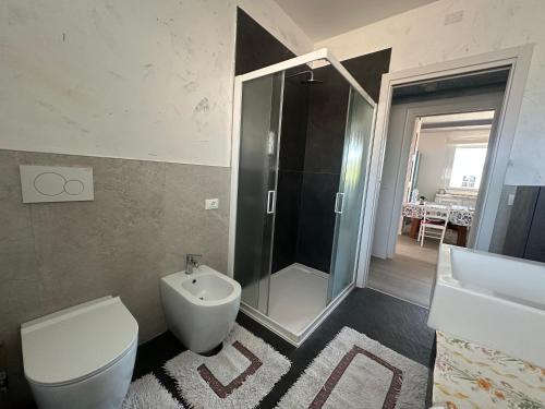 a bathroom with a shower and a toilet and a sink at jesolo wellness house in Lido di Jesolo