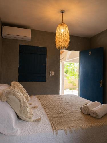 a bedroom with a large bed with towels on it at Kayma Beach in Guriú
