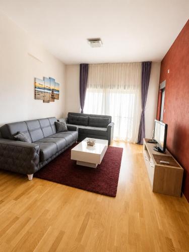 a living room with a couch and a table at SeaSideApartamn in Boreti