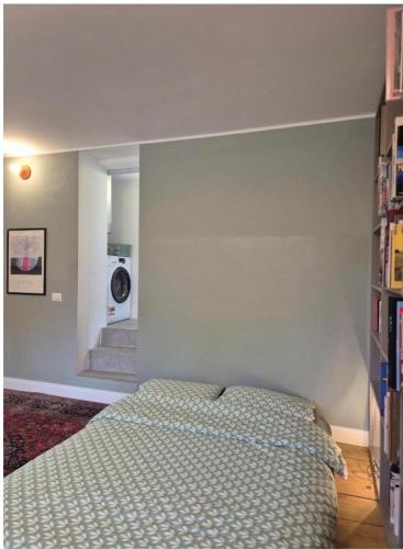 a bedroom with a bed and a hallway with a staircase at Loft Library by Lago Maggiore Rentals in Oggebio