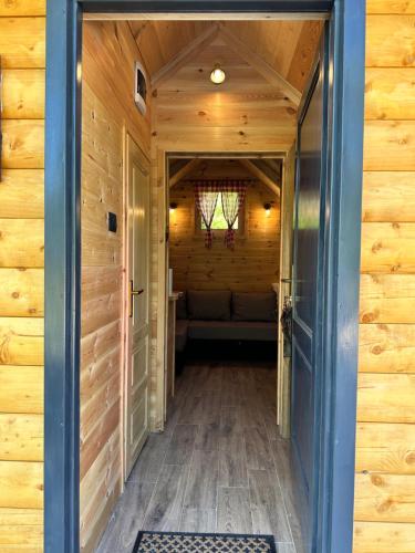 a hallway in a log cabin with a door open at Log Cabin in Blatina