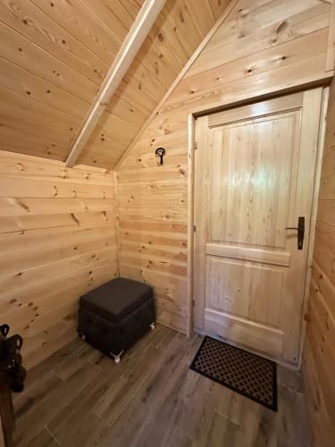a small room with a door in a wooden cabin at Log Cabin in Blatina