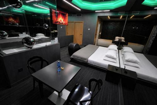 a room with a bed and a table and a mirror at Motel Venus Madrid Norte in Meco
