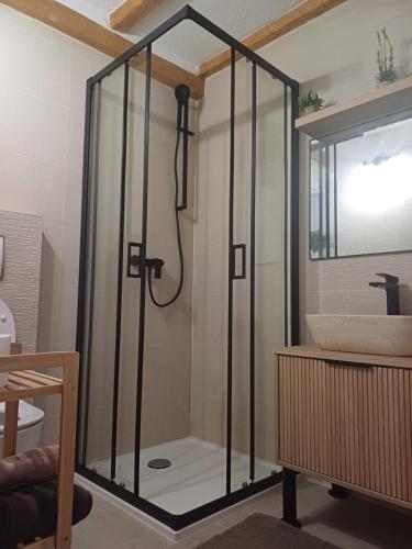 a shower with a glass door next to a sink at Terra Verde in Omiš