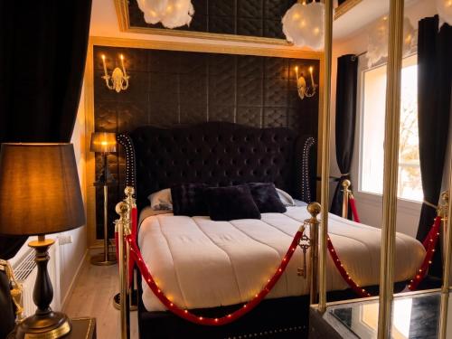 a bedroom with a bed with a red rope around it at Caporizon - La Damoiselle in Chancelade