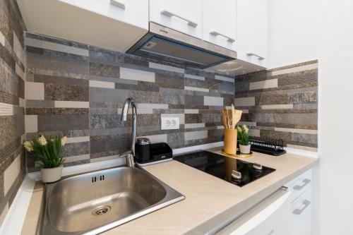 a kitchen with a sink and a counter top at Arte Luxury Pool Apartmets in Ulcinj