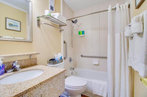 a bathroom with a sink and a toilet and a shower at Waterfront, Sunset views from balcony, Heated pool in Tampa