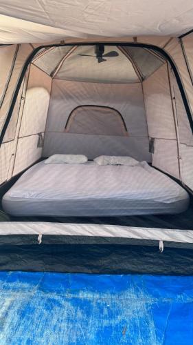 a bed in the front of a tent at StNicholas Ranch Corfu Wild Camping in Benitses