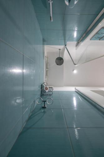 a room with a blue tile floor and a swimming pool at Libeccio - flat with terrace and sea view, perfect for up to 3 guests in Maiori