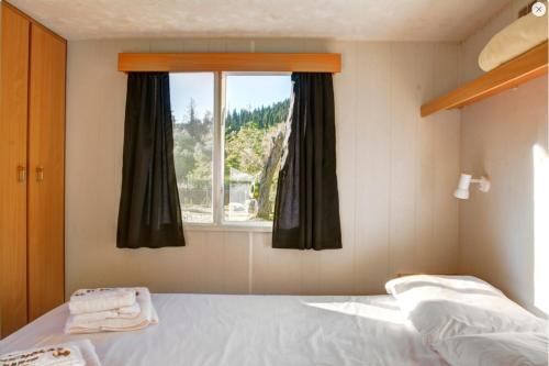 a bedroom with a bed and a window at St.Nicholas Ranch Corfu in Benitses