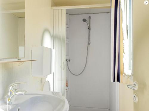 a white bathroom with a shower and a sink at St.Nicholas Ranch Corfu in Benitses