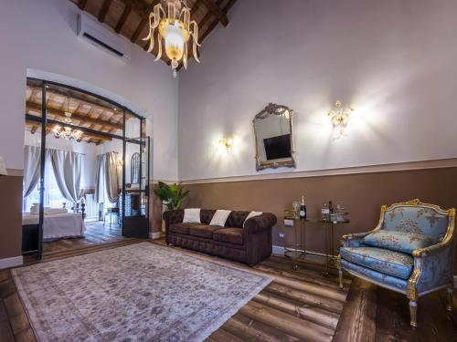 a living room with a couch and a chair at Palazzo Ravenna in Ravenna