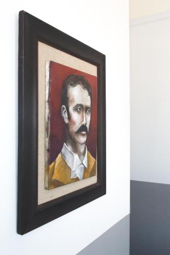 a painting of a man with a mustache at Hotel Palisade in Sydney