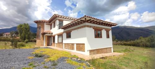 a house in the middle of a field at Casas Villa de Leyva in Villa de Leyva