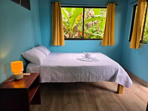 a bedroom with a bed and a window at Senda Adults Only Hostel in Manuel Antonio