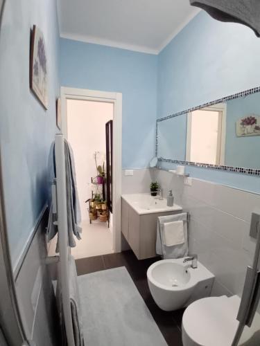 a bathroom with a white toilet and a sink at La casa dei gelsomini in Alassio