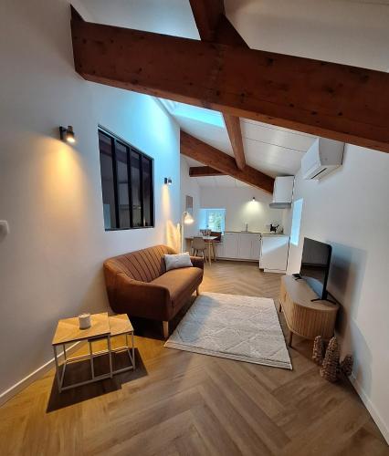 a living room with a couch and a table at Les Gites de la Bastide in Ribes