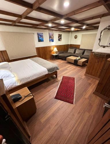 a large room with a bed and a couch at Mon Refuge 120 in Bcharré