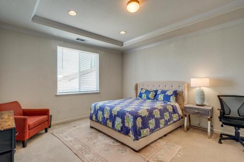 a bedroom with a bed and a chair and a window at Pool Table & Home Gym! Manteca Group Getaway in Manteca