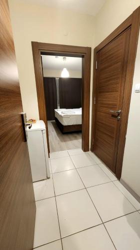 a hallway with a door and a room with a bed at Moda Hotel in Kırklareli