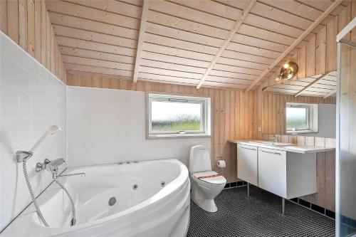 a bathroom with a tub and a toilet and a sink at 507-Lemvig-Lyngsletten-11 in Lemvig