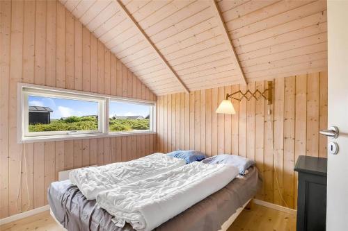 a bed in a room with a window at 507-Lemvig-Lyngsletten-11 in Lemvig