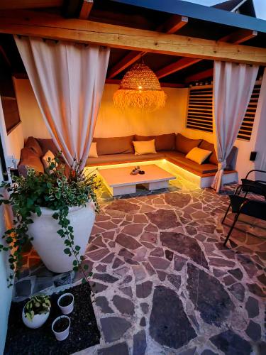 a living room with a couch and a table at Garden Relax Bungalow "Deluxe Hotel Rooms, Pool, Parking" in Banja Luka