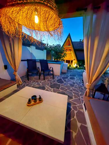 a room with a table with a pair of shoes on it at Garden Relax Bungalow "Deluxe Hotel Rooms, Pool, Parking" in Banja Luka