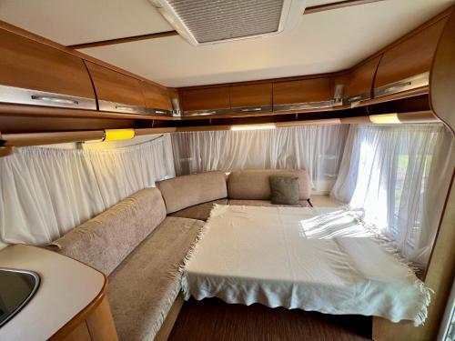 a living room with a couch and a window at Neptun Beach Caravans in Ulcinj