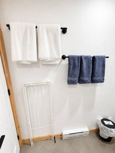 a bathroom with towels and a radiator and towels at Lake Hideaway with BBQ, Fire Pit & Horses in Sainte-Marguerite