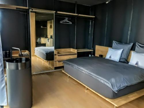 a bedroom with a large bed and a mirror at Design apartmán in Teplice