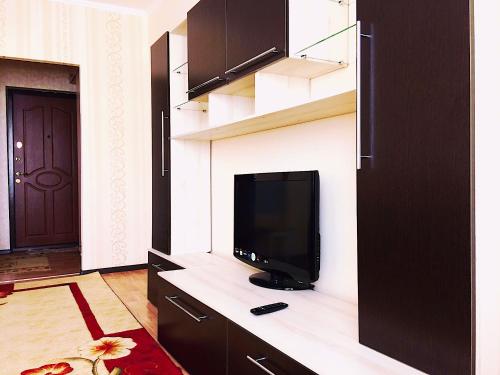 a living room with a flat screen tv on a counter at Apartment on Infinity Astana in Astana