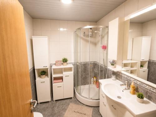 a bathroom with a shower and a sink and a tub at SeaSideApartman3 in Budva