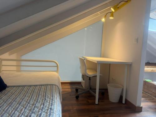 a bedroom with a bed and a desk and a desk at Loft Adrimar in Santoña