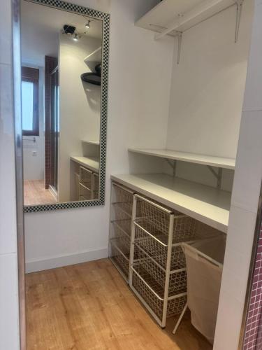 a dressing room with shelves and a mirror at Loft Adrimar in Santoña
