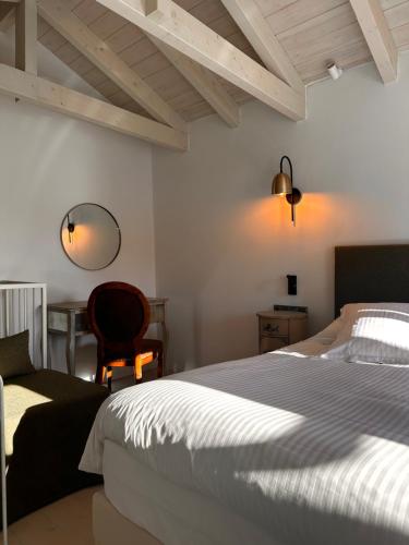 a bedroom with a bed and a chair and a desk at Pirrion Villas in Ano Pedina