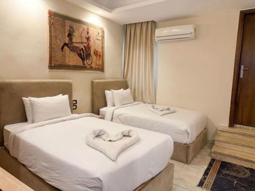 a hotel room with two beds with a heart on them at Explore Pyramids View in Cairo