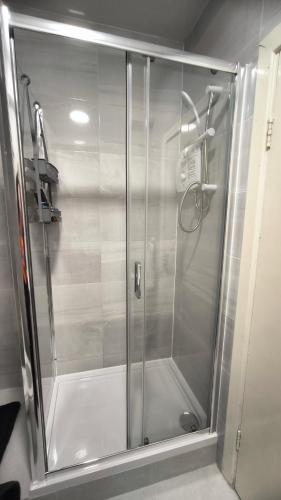 a shower with a glass door in a bathroom at Crandford in Dublin