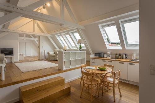 a kitchen and living room with a table and chairs at Landhaus Reverchon in Filzen