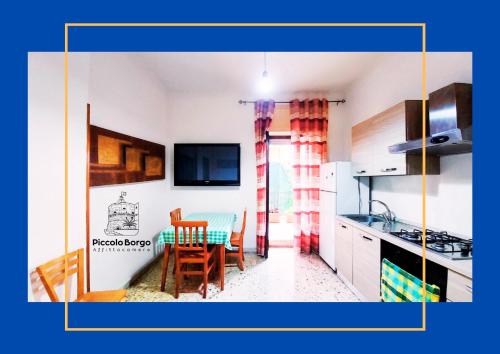 a kitchen with a table and a dining room at Piccolo Borgo Affittacamere BIKE FRIENDLY in Taranto